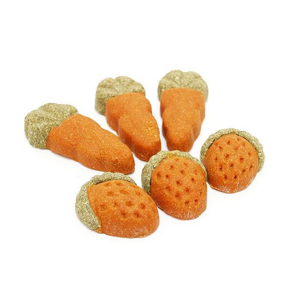 Orange carrot and strawberry shaped dog dental chews on white background
